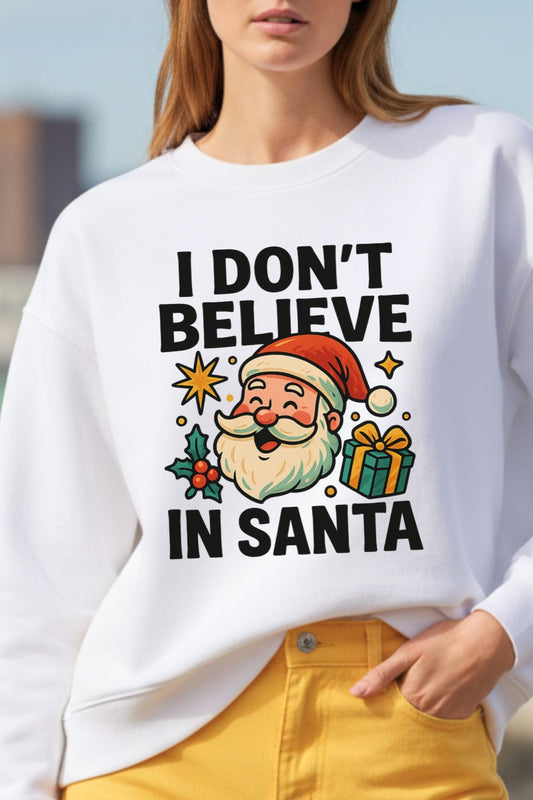 close up of a woman wearing a white oversized sweatshirt with a Christmas-themed graphic and text.