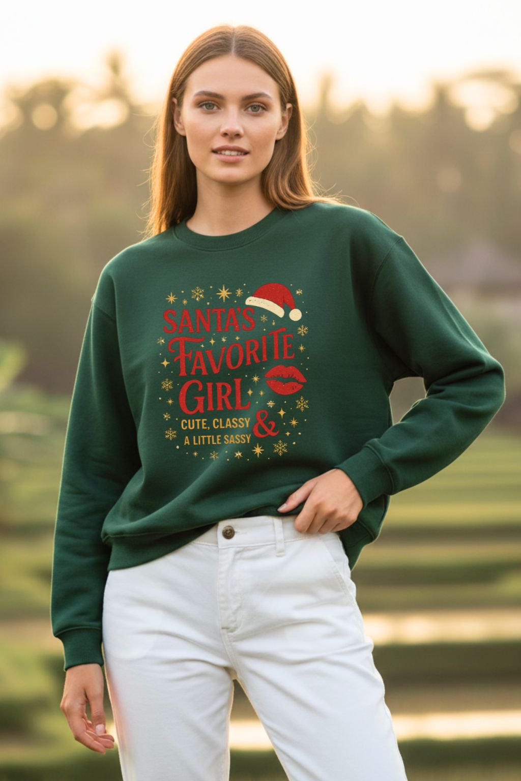 Woman wearing a bottle green oversized sweatshirt with Christmas-themed text outdoors