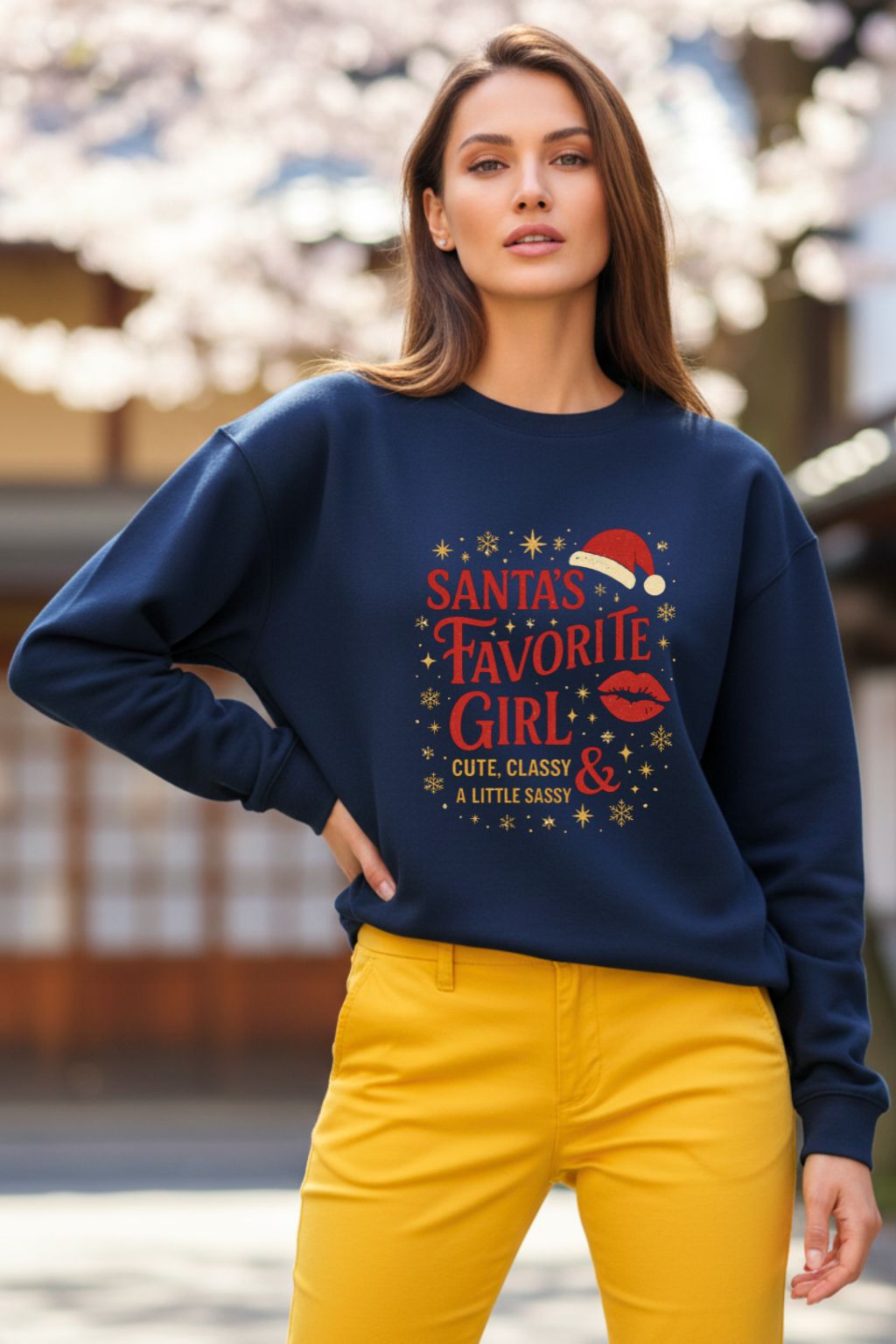 Woman wearing a navy blue oversized sweatshirt with festive text and graphics, standing outdoors.