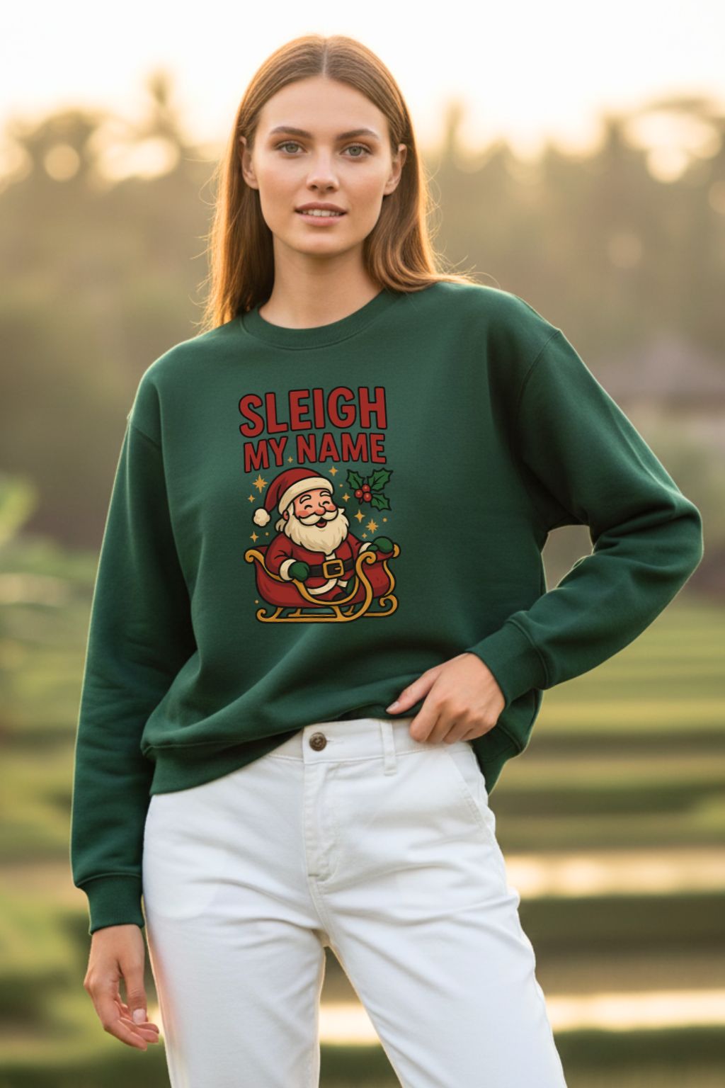Woman wearing a bottle green oversized sweatshirt with 'Sleigh My Name' text and Santa Claus graphic outdoors.