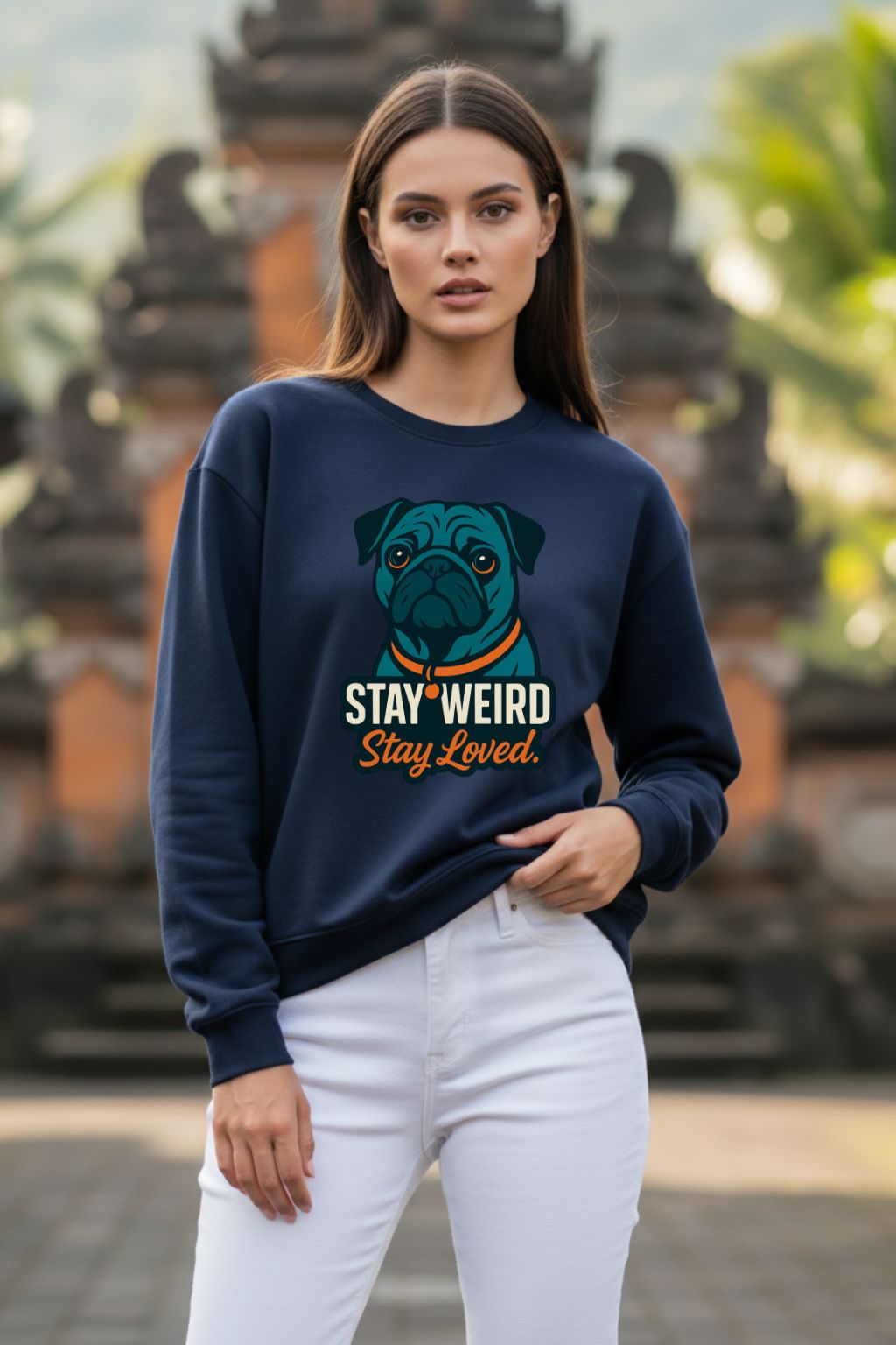 Woman wearing a navy blue sweatshirt with a dog graphic and text, standing in front of a blurred background.