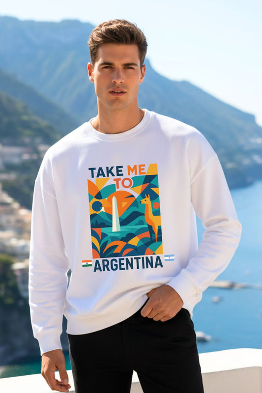 Man wearing a white oversized sweatshirt with 'Take Me to Argentina' graphic in front of a scenic background.