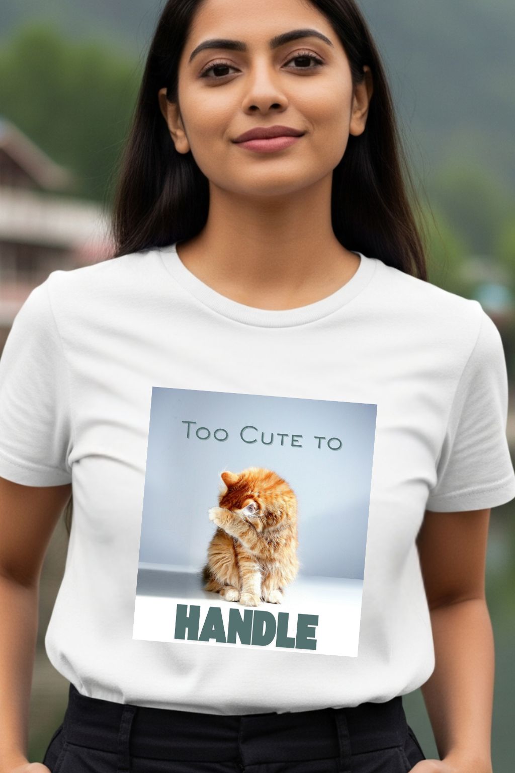 Close-up shot of a woman modeling ZUPPI's "Too Cute to Handle" white T-shirt, showing the detailed graphic print of a cute cat and the phrase