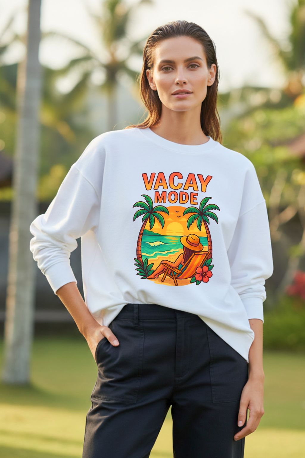 Woman wearing a white sweatshirt with 'Vacay Mode' design outdoors.