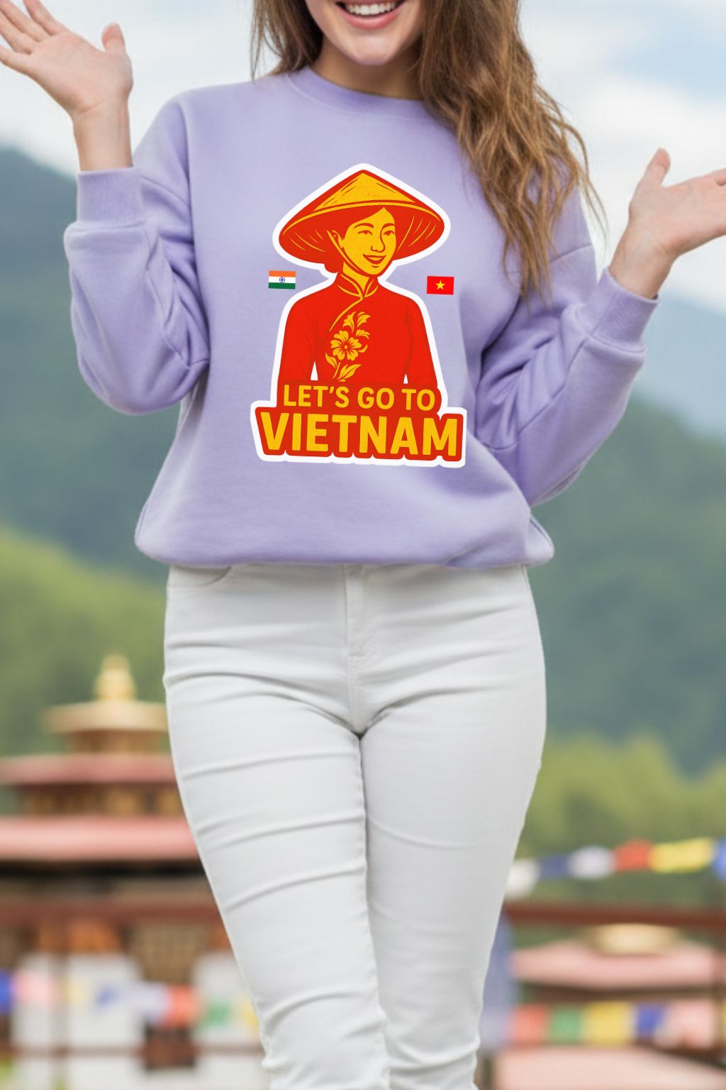 close up of a woman wearing a lavendar oversized sweatshirt with a 'Let's Go to Vietnam' graphic in a scenic outdoor setting.
