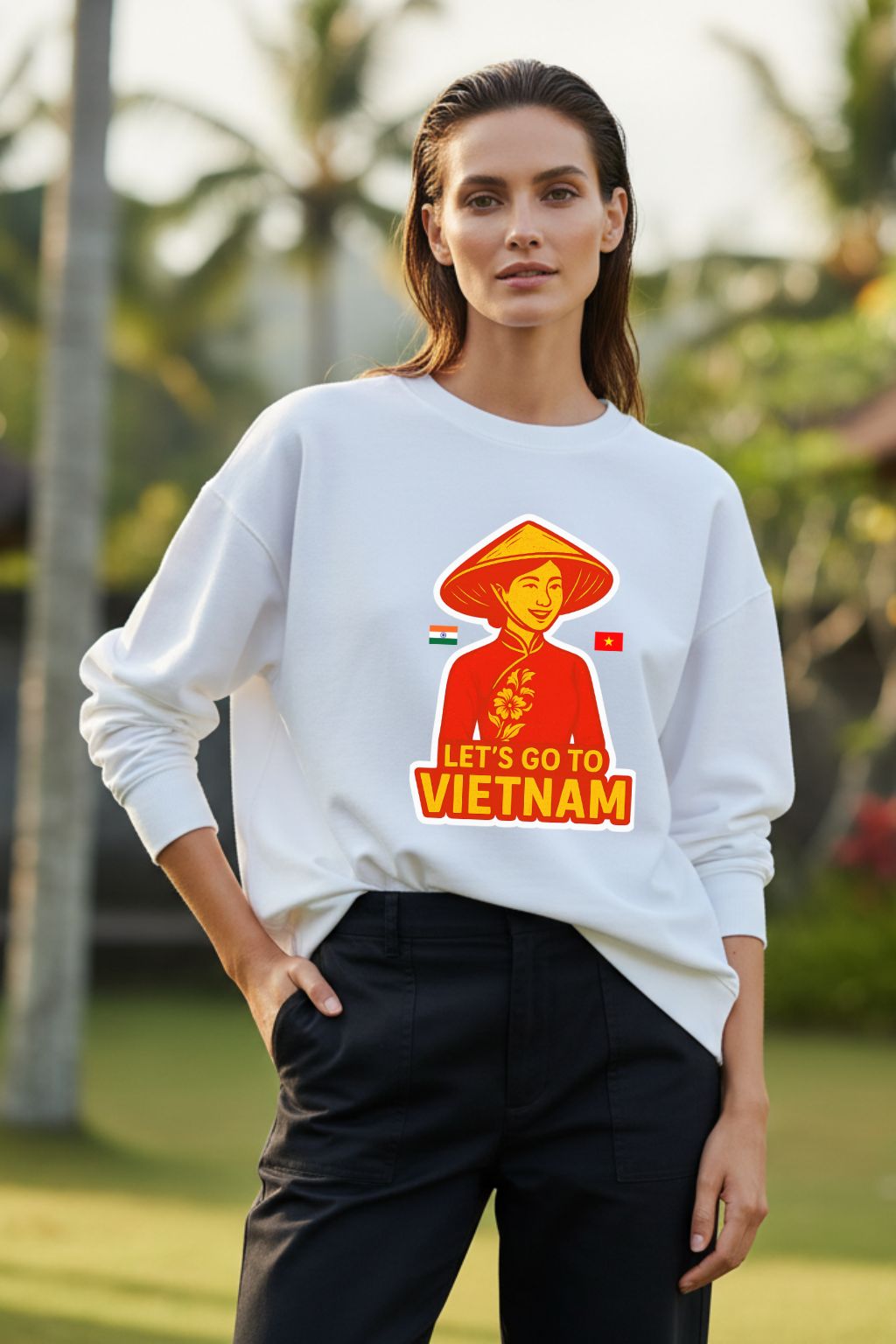 Woman wearing a white oversized sweatshirt with a 'Let's Go to Vietnam' graphic design outdoors.