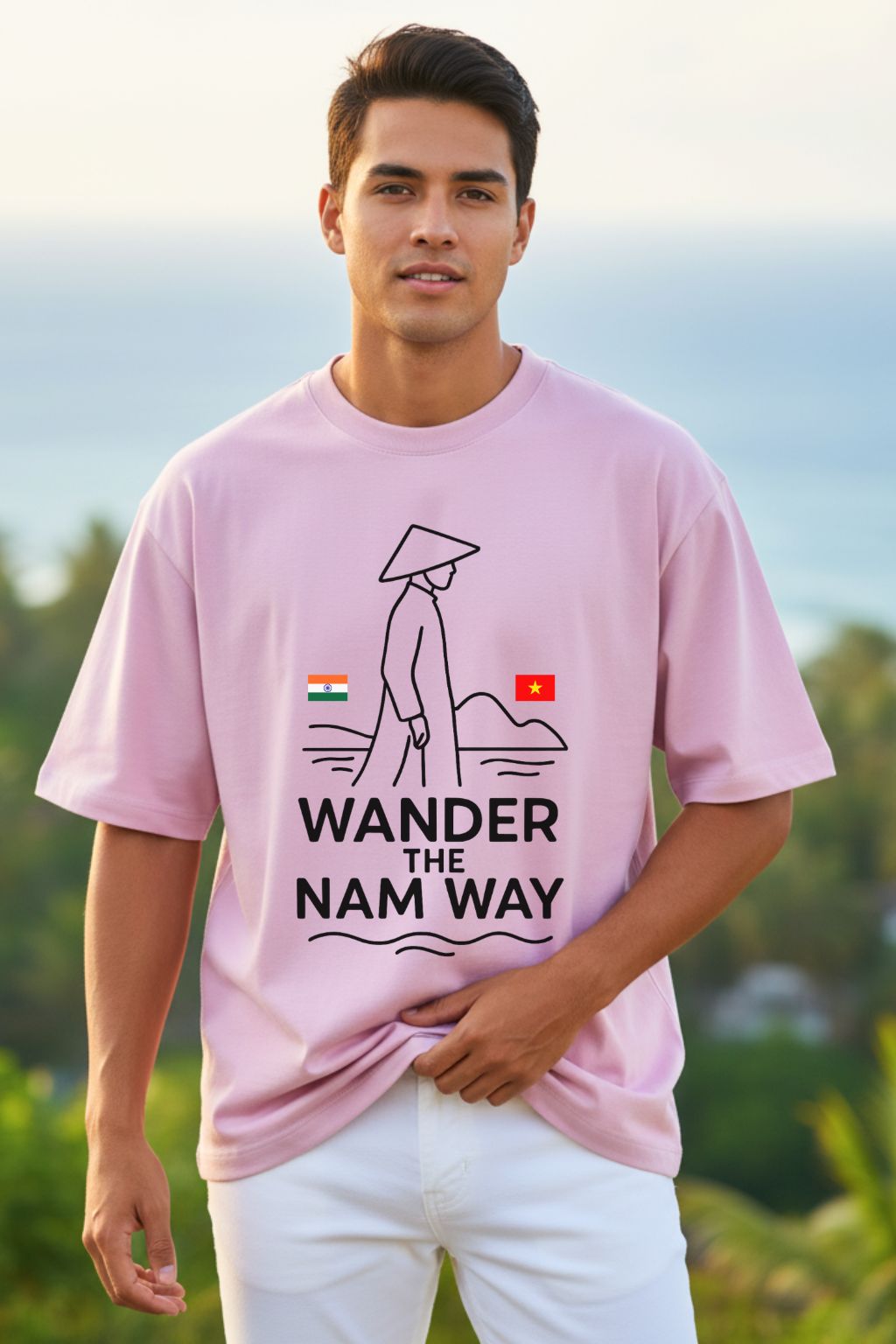 Man wearing a pink t-shirt with 'Wander the Nam Way' design outdoors.