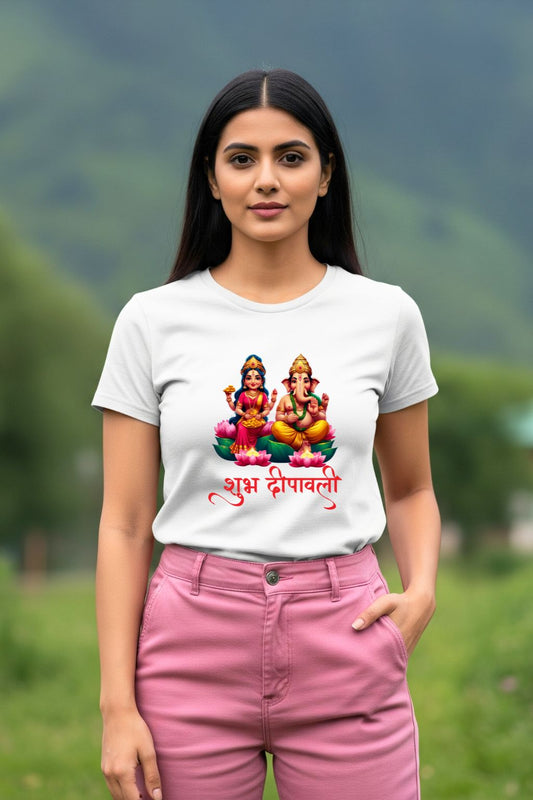 A woman wearing a Lakshmi and Ganesha Divine Duo white t-shirt, with a festive design, standing outdoors.