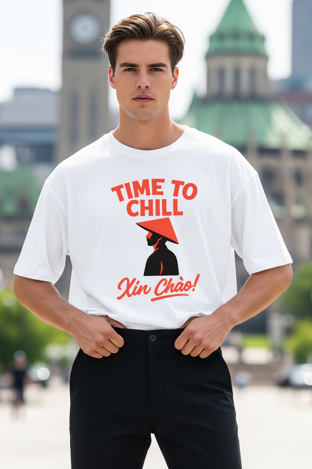 Man wearing a white t-shirt with a graphic design and text, standing in an urban setting.