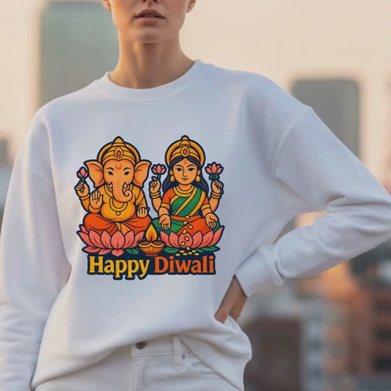video of a young woman wearing a white oversized sweatshirt with a "ganesha lakshmi diwali" design